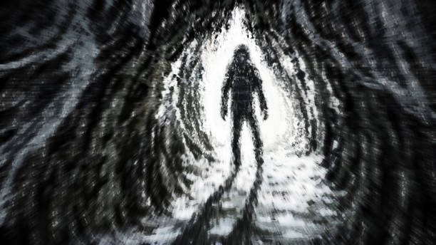 istock Man stands in rays of light at entrance to the cave. 1035801784