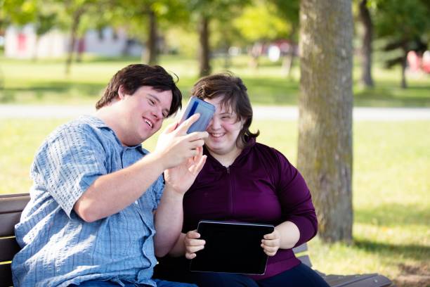 istock Couple with Down Syndrome working doing selfie with mobile phone 1035803958