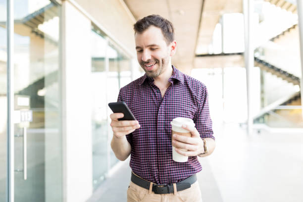 istock Man Using Mobile Phone In Shopping Mall 1035804126
