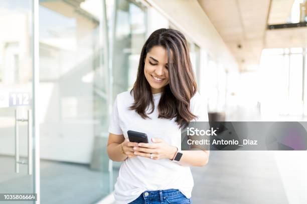 Woman Reading Incoming Notification On Smartphone Stock Photo - Download Image Now - Banking, On The Move, Mobile Phone