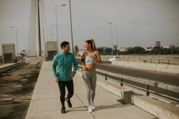 istock Young couple running in urban enviroment 1035814044