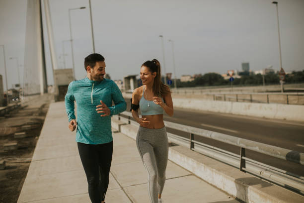 istock Young couple running in urban enviroment 1035814106