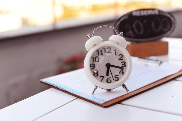istock white clock alarm with a turntable on the table outside in a restaurant with a reservation 1035819444