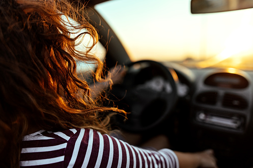 Woman driving car in romantic environment