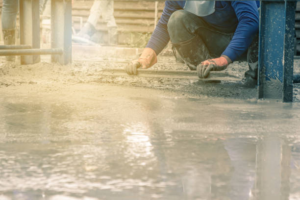 istock Man sitting and using a wooden spatula for cement after Pouring ready-mixed concrete 1035835122