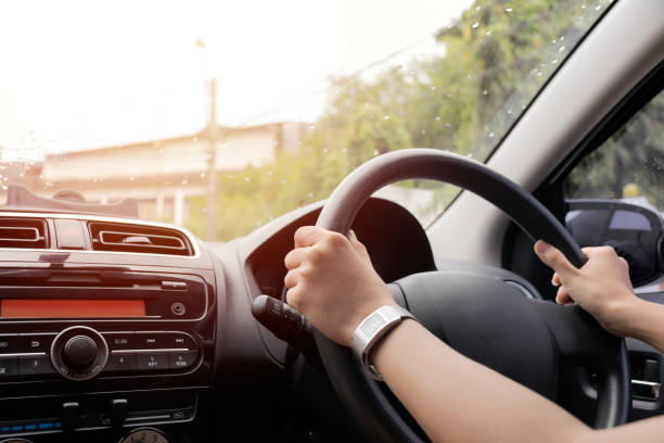 istock The girl was driving while the rain was falling. 1035844974