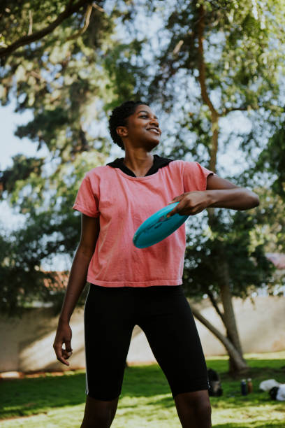 istock Active woman throwing a frisbee in the park 1035847822