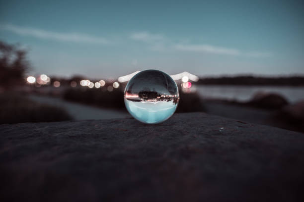 istock Glass ball infront of ocean sunset 1035866924