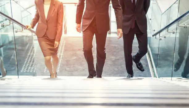 Photo of Business persons going up the stairs.