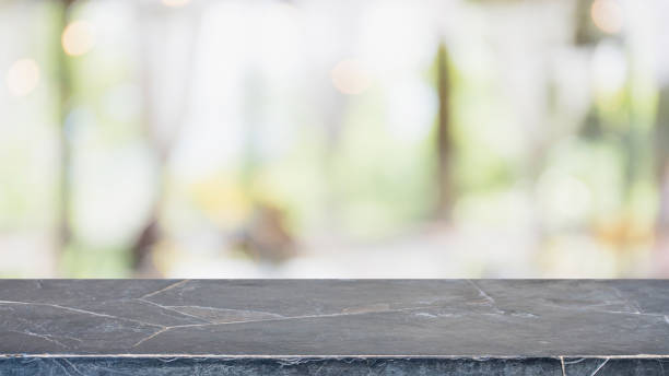 istock Empty black marble stone table top and blurred bokeh cafe and coffee shop interior background with vintage filter - can used for display or montage your products. 1035884052