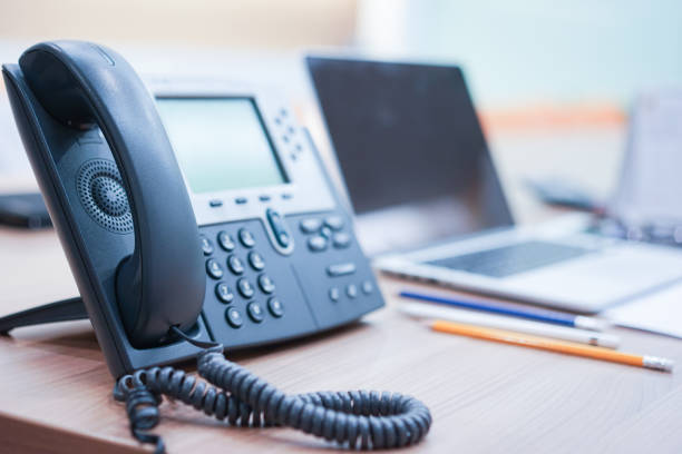istock close up soft focus on telephone devices at office desk for customer service support concept 1035892840