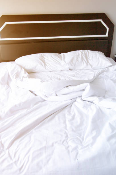 istock Close up white bedding sheets and pillow .Sunshine in morning. 1035893082