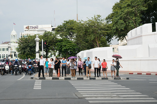 Bangkok, Thailand - September 7, 2018: People wait for green pedestrian traffic light to cross the street at Maha Kan Fort, Bangkok