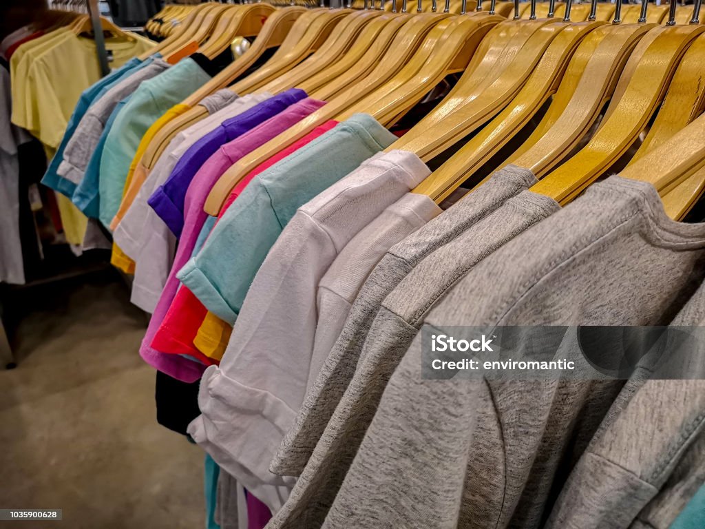 https://media.istockphoto.com/id/1035900628/photo/rows-of-colorful-t-shirt-tops-hanging-on-coat-hangers-from-a-rail-for-sale-in-a-high-street.jpg?s=1024x1024&w=is&k=20&c=bS5JpPharMQpIQYKtNJnT6fzCoy_MuQSgYmnKi6GyKw=