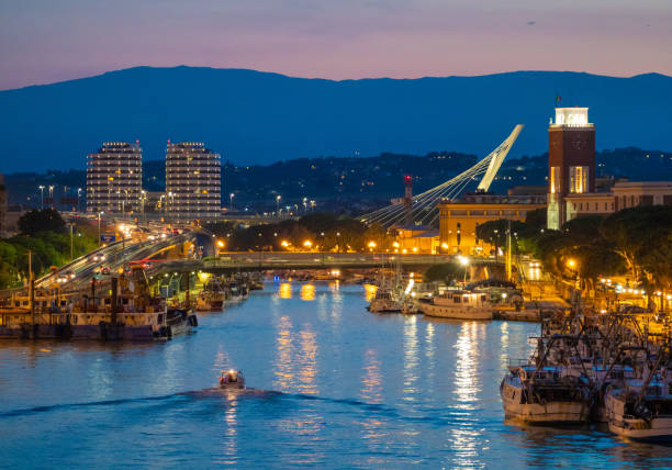 Pescara (Abruzzo, Italy) Pescara, Italy - 18 August 2018 - The view in the dusk from Ponte del Mare monumental bridge in the canal and port of Pescara city, Abruzzo region. abruzzi photos stock pictures, royalty-free photos & images