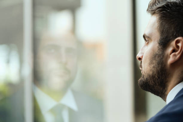 istock Young businessman watching out of window 1035921570