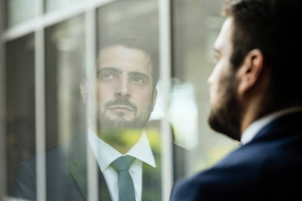istock Young businessman watching out of window 1035921572