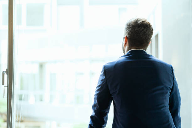 istock Young businessman watching out of window 1035921584