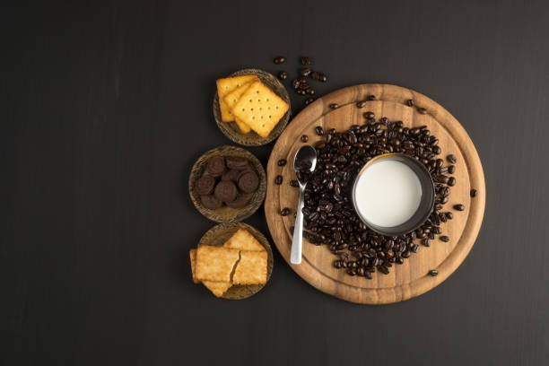 coffee bean and Biscuit on wood board color black stock photo