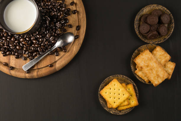 coffee bean and Biscuit on wood board color black stock photo