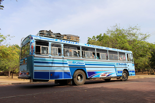 The public bus (or a chartered one) stopped at Polonnaruwa Ancient City. Taken in Sri Lanka, August 2018.