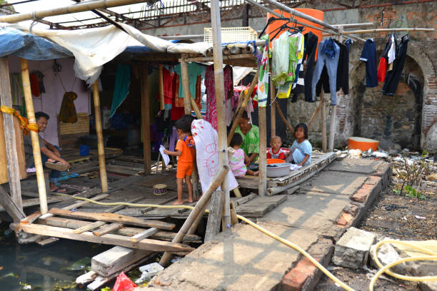 Living in Indonesia Home of a poor family on a sunny day in downtown Jakarta, Indonesia jakarta slums stock pictures, royalty-free photos & images