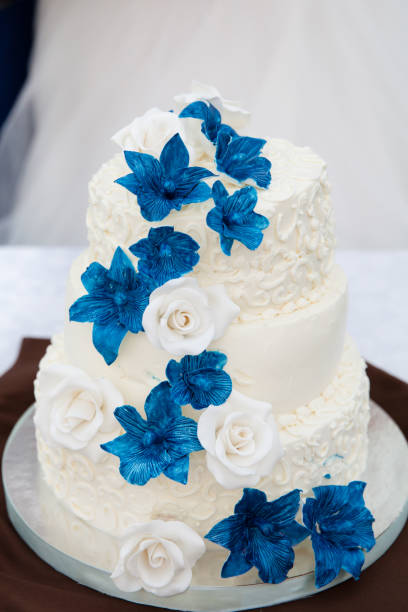 istock white wedding cake with blue flowers 1035933590