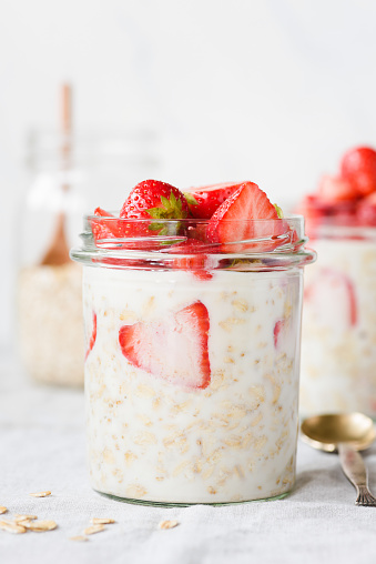 Overnight oats with strawberries in a jar. Healthy diet breakfast, healthy food, modern trendy lifestyle concept