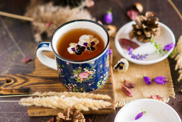 istock Flower tea: pansies, edible flowers, on a light background 1035941480