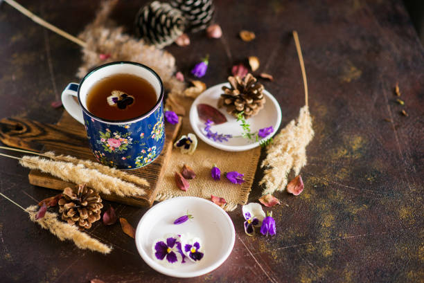 istock Herbal tea: pansies, petals, edible flowers, on a light background 1035941490