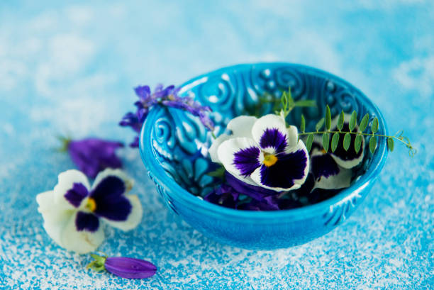 Flower tea: pansies, edible flowers, on a light background
