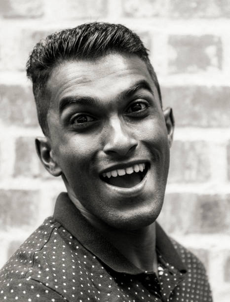 istock Monochromatic image of an Indian man smiling widely while looking at the camera. 1035944366