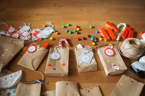 preparing the advent calendar. bags and sweets on the table. idea of crafts for Christmas.