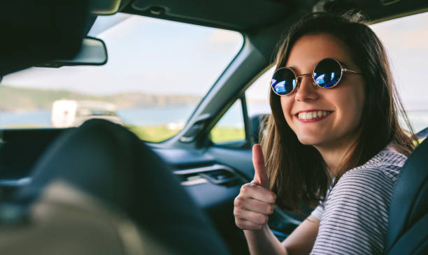 女の子を車の中親指を行う - automotive accessories ストックフォトと画像