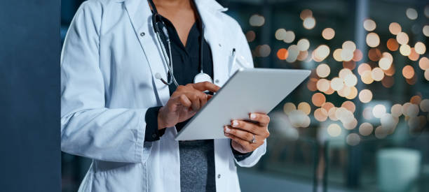 Evaluating healthcare reports Closeup shot of an unrecognizable doctor using a digital tablet in a hospital at night medical record photos stock pictures, royalty-free photos & images