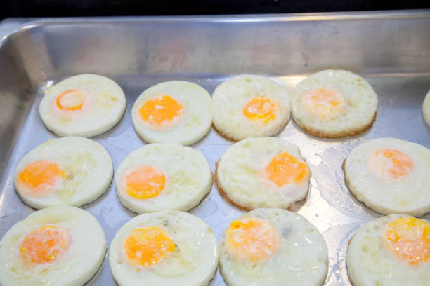 Fried eggs in the tray for morning buffet.  English breakfast buffet in a hotel. Eggs Sunny Side Up in a tray of food for breakfast.