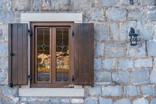Small wooden window and shutters of a local cafe in Petrovac, Montenegro