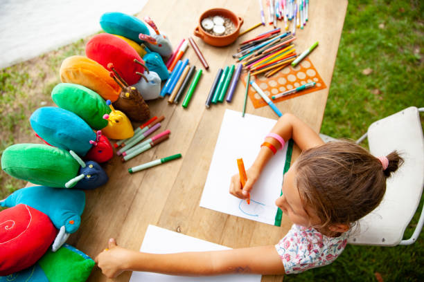 istock Young Girl Drawing at Summer Art's Class 1035970346
