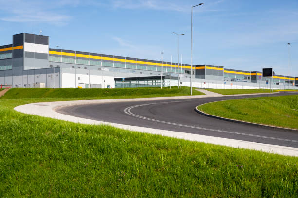 istock Drive way to large distribution warehouse building 1035971142
