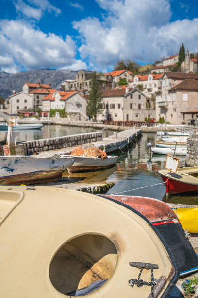 istock Anchored boats on the shore in Perast 1035974302
