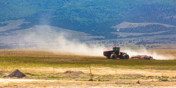 istock Red tractor with large wheels on a field in Utah 1035975222