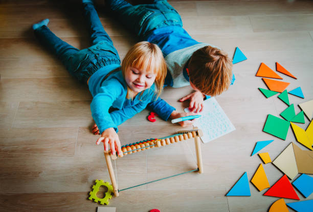 istock little boy and girl learn to write and calculate numbers 1035982136