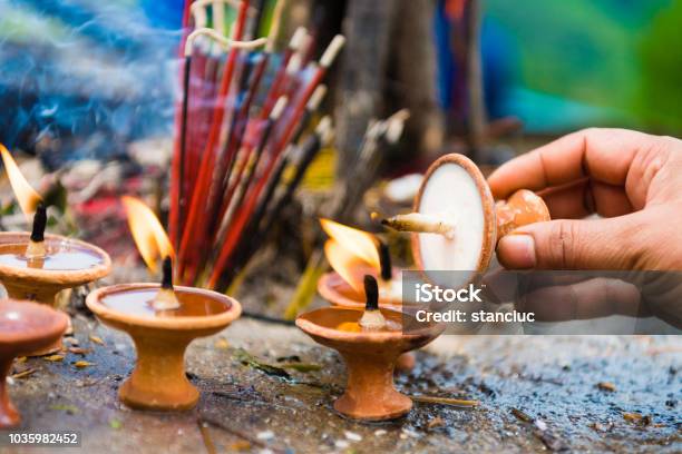 Woman Hand With Terracota Oil Lamps As Religious Offerings At Temple In Nepal Incence Sticks Over Blurred Background Stock Photo - Download Image Now