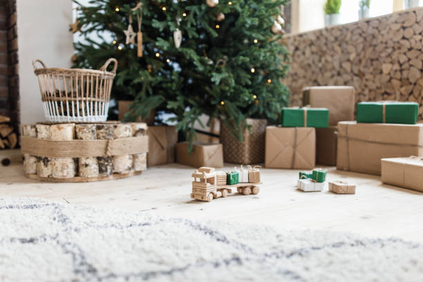 istock Wooden toy car with christmas gift boxes on top 1035984272