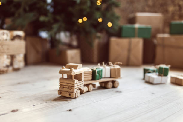 istock Wooden toy car with christmas gift boxes on top 1035984814