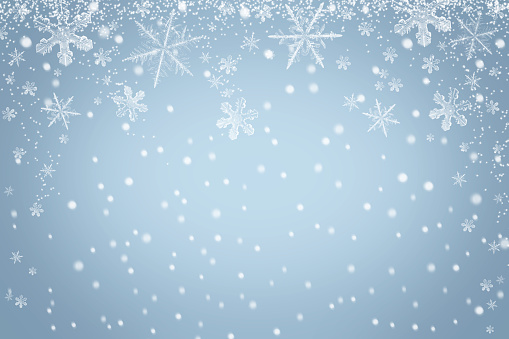 Winter snowflakes background with falling snow. Abstract light blue Christmas backdrop