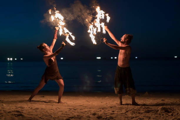 circus beach - fire dancer photos et images de collection