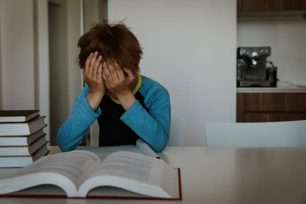 istock little boy exhausted tired of doing homework,overload 1035985668