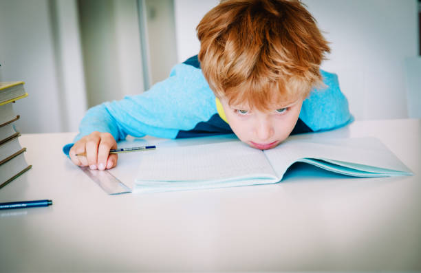 istock little boy exhausted tired of doing homework,overload 1035985700