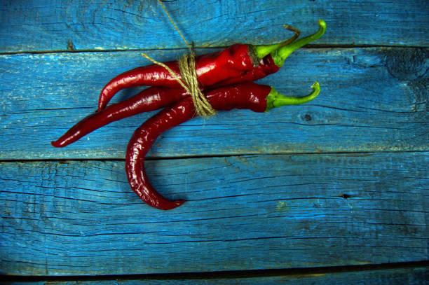 red bitter pepper on an old wooden background stock photo